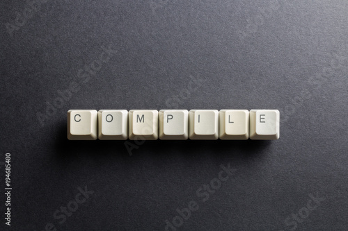 Word compile made using computer keyboard buttons on a black background. IT technology concept.