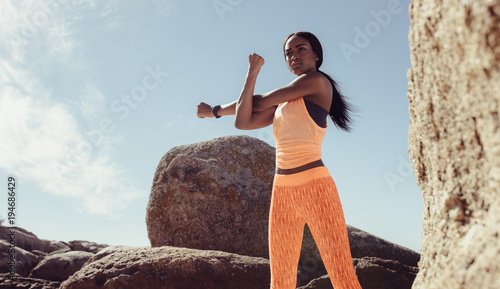 Fitness woman doing war-up exercise at the beach