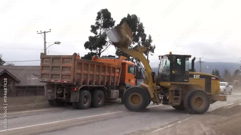 A backhoe help to remove ashes from Ensenada, a town affected by Calbuco Volcano Eruption. A backhoe help to remove ashes from Ensenada, a town affected by Calbuco Volcano Eruption.