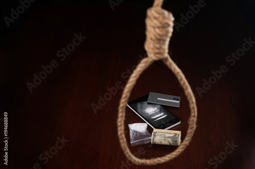 Concept. The noose hanging from the ceiling which are drugs.