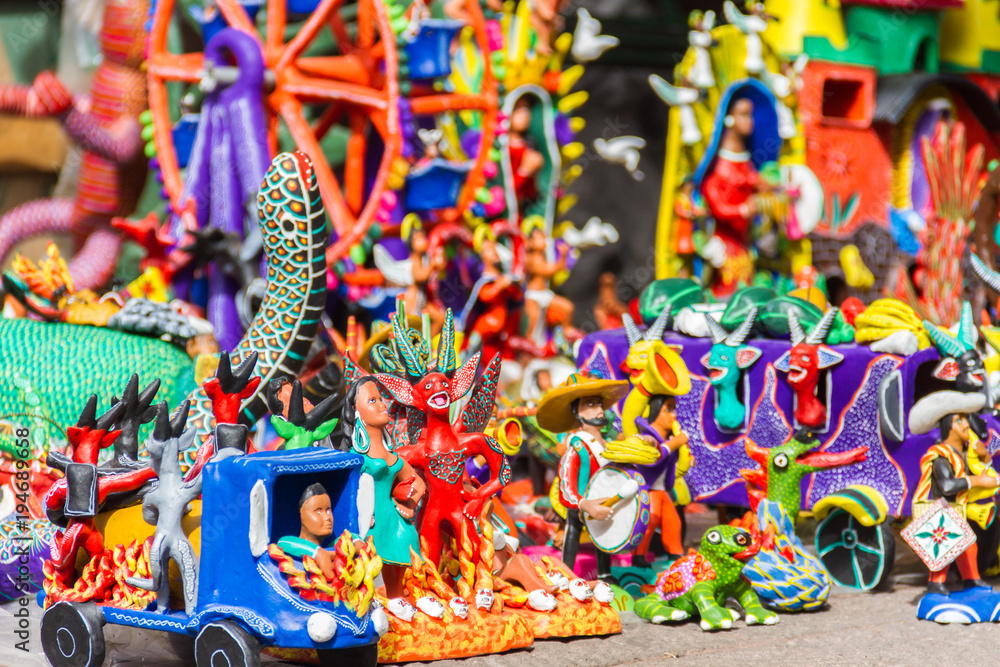 Naklejka premium Ocumicho figures from a public street market in Mexico. These figures are part of the typical culture of the south of Mexico.