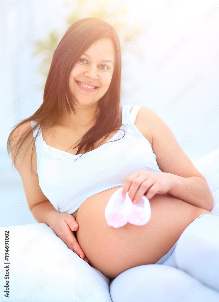 beautiful pregnant woman sitting in the living room. beautiful pregnant woman sitting in the living room.