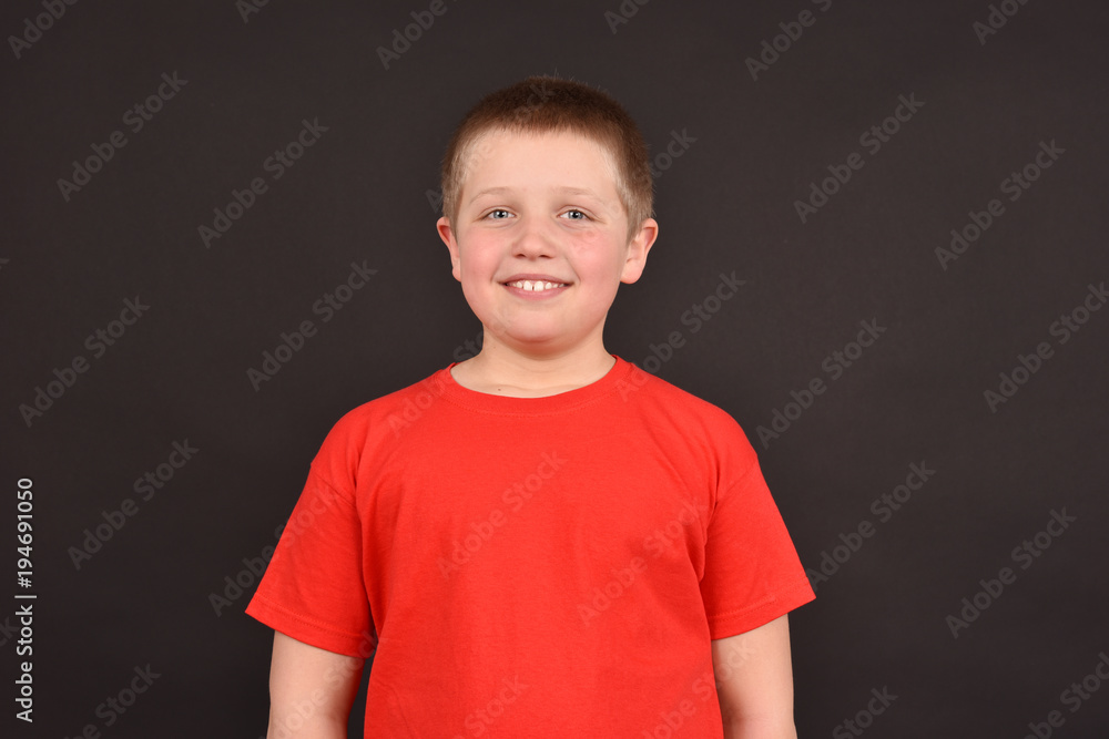 Cheerful boy on a black background. Isolated portrait of a child. Happy child. Cheerful boy on a black background. Isolated portrait of a child. Happy child.