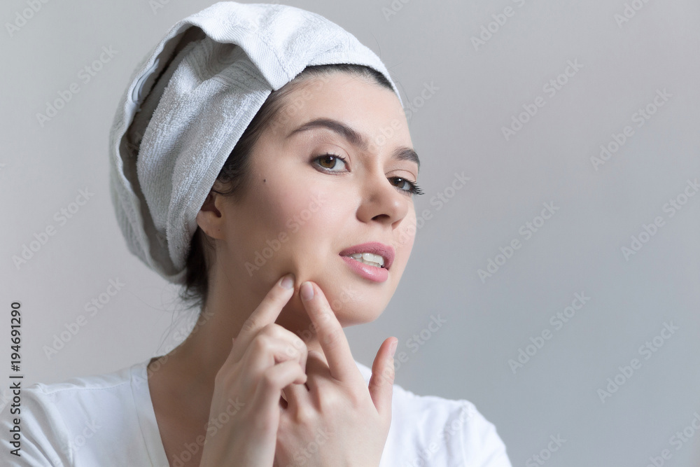 Young woman with acne in bathroom. Portrait of teenager girl looking at the mirror on her skin. Beauty, skin care lifestyle concept. Young woman with acne in bathroom. Portrait of teenager girl looking at the mirror on her skin. Beauty, skin care lifestyle concept.