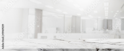 Empty white marble stone tabletop and blurred bokeh office interior space banner background - can used for display or montage your products. © bunditinay