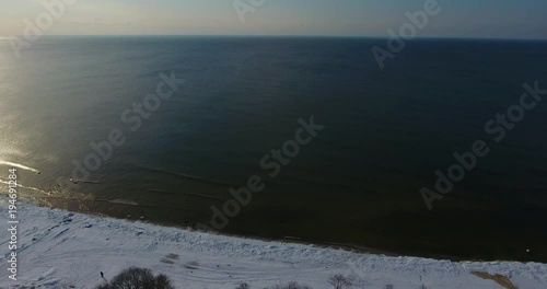 Aerial view cemetery by the coastline in a winter time. Movement from the sea to the land. photo