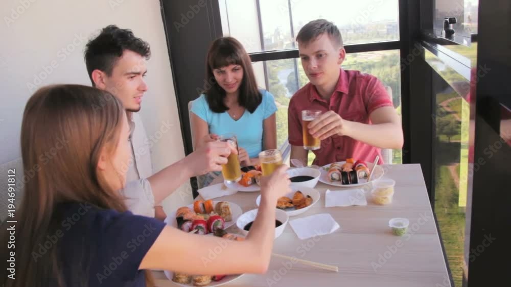 Two young couples celebrate during dinner, cheers Two young couples celebrate during dinner, cheers
