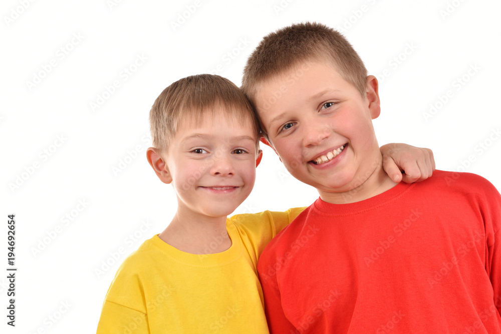 Two boys on a white background. Children in T-shirts. Good mood. Sincere childhood. Two boys on a white background. Children in T-shirts. Good mood. Sincere childhood.
