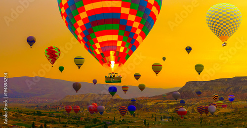 tourist attraction of Cappadocia - Hot air balloons landing in a mountain