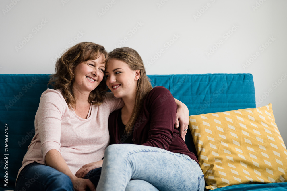 Mother embracing her teen daughter with love Mother embracing her teen daughter with love