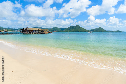 Pigeon Island Beach - tropical coast on the Caribbean island of St. Lucia. It is a paradise destination with a white sand beach and turquoiuse sea. photo