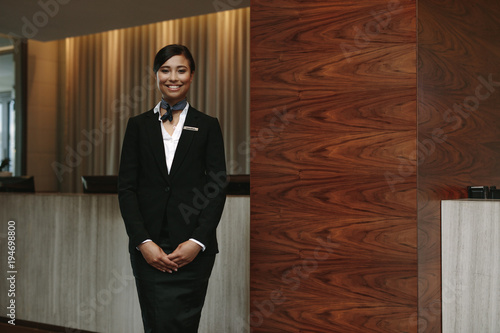 Canvastavla Female receptionist standing at hotel front desk
