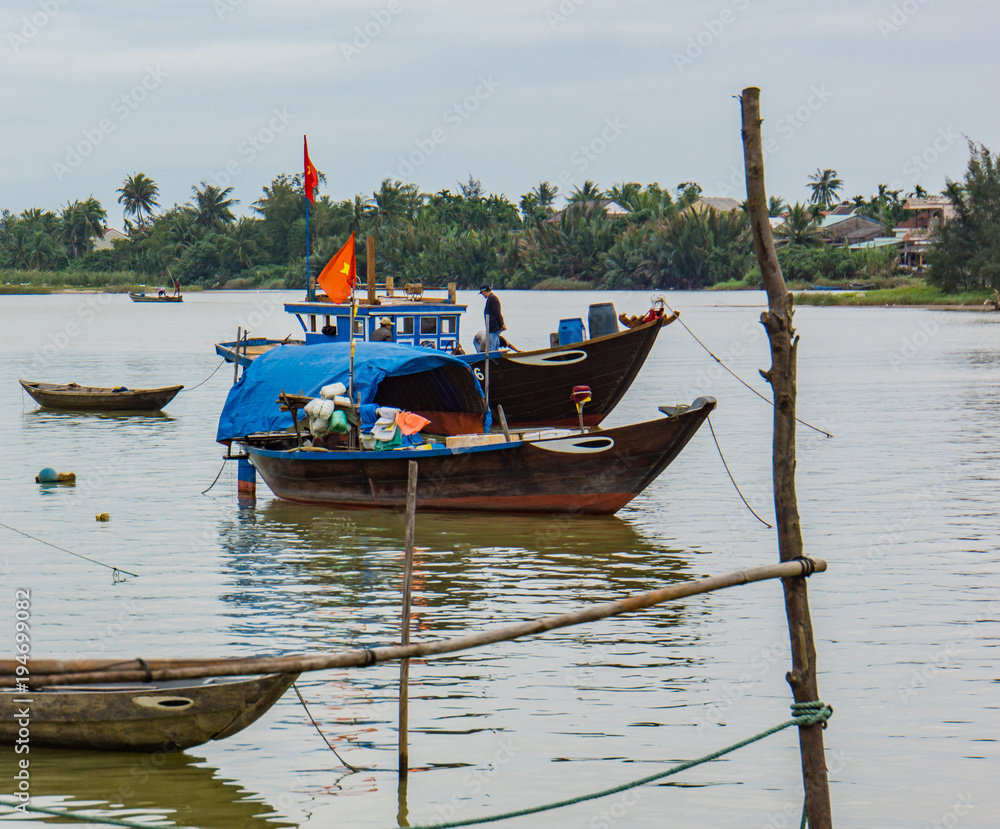 fishing boats anchored on the side of the river