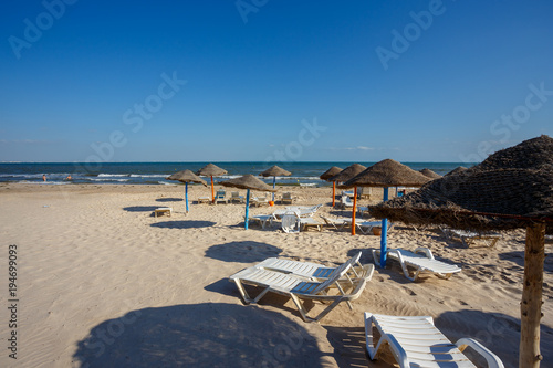 Beach umbrellas on sandy Tunis beach © ArtushFoto