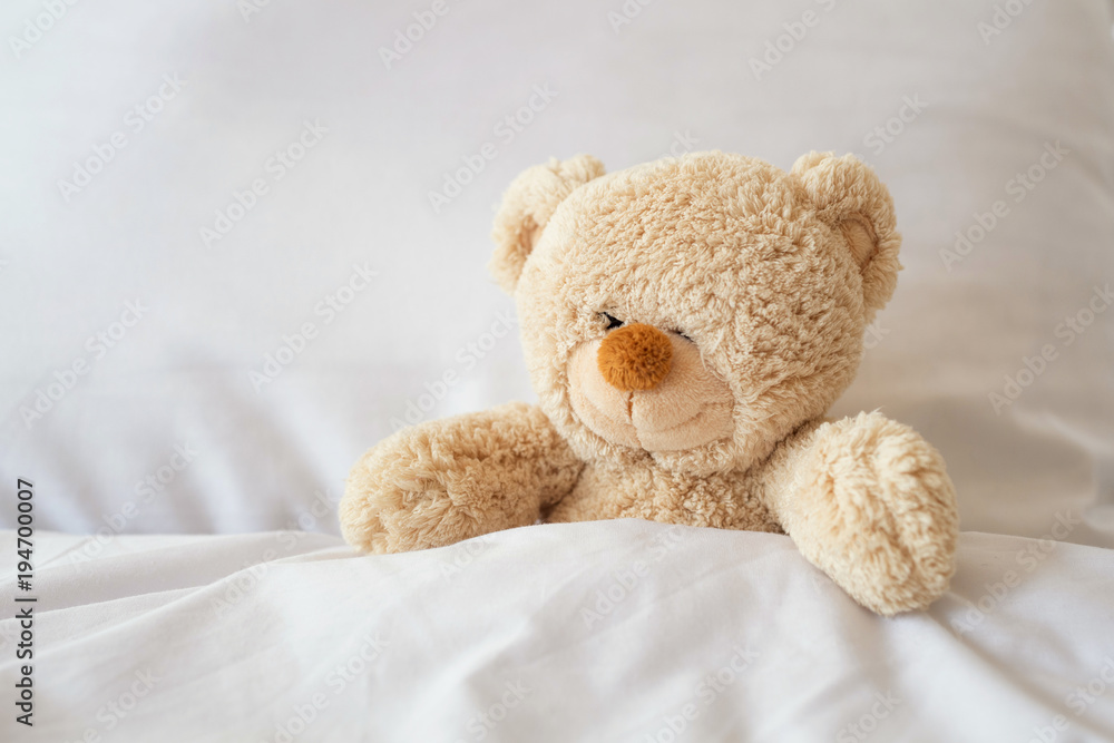 Sleeping teddy bear on white bed. Sleeping teddy bear on white bed.