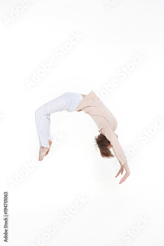 dancer doing somersault isolated on white background. Contemporary ballet dancer man doing back flip jump