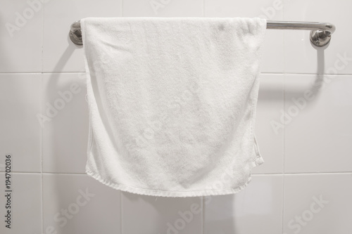 white towel hang on stainless steel in bathroom