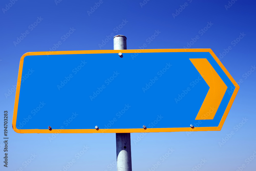 Road sign with empty space and blue sky in the background. Road sign with empty space and blue sky in the background.