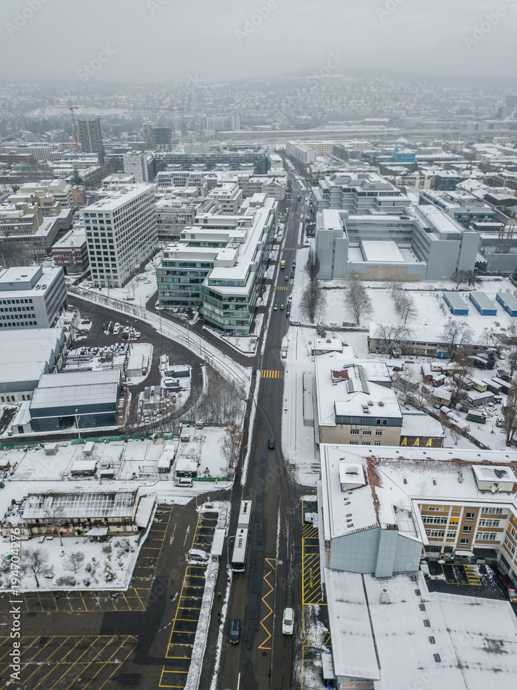 Fototapeta premium Aerial view of Zurich in Switzerland with snow covered rooftops