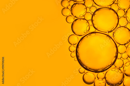 Abstract bubbles (vegetable oil on water). Yellow background