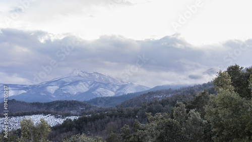 Snowy peak mountains on a winter cloudscape landscape