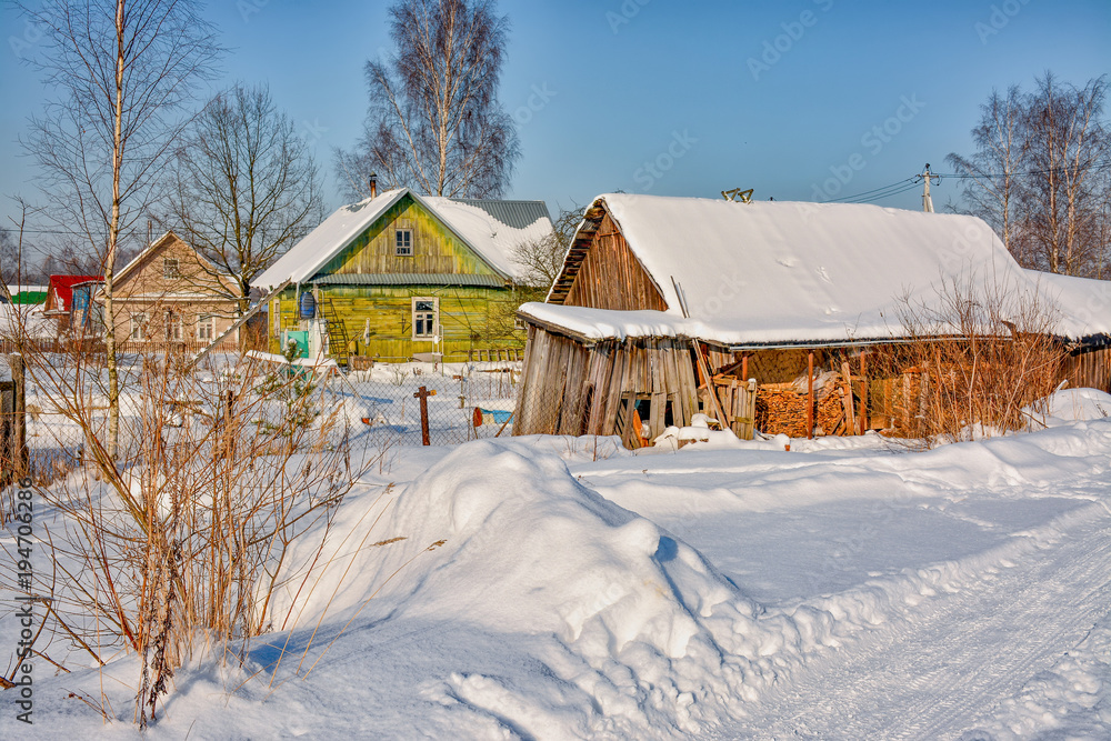 Sunny winter day in the countryside. The sign of winter-icicles