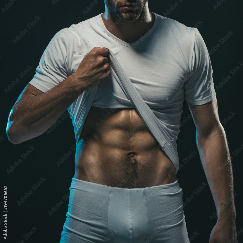 Sexy erotic handsome young man in underwear. Muscular sexy young man in  white t-shirt which shows the pres. Sexy, young, handsome male fitness  model. Black Friday. Stock Photo | Adobe Stock