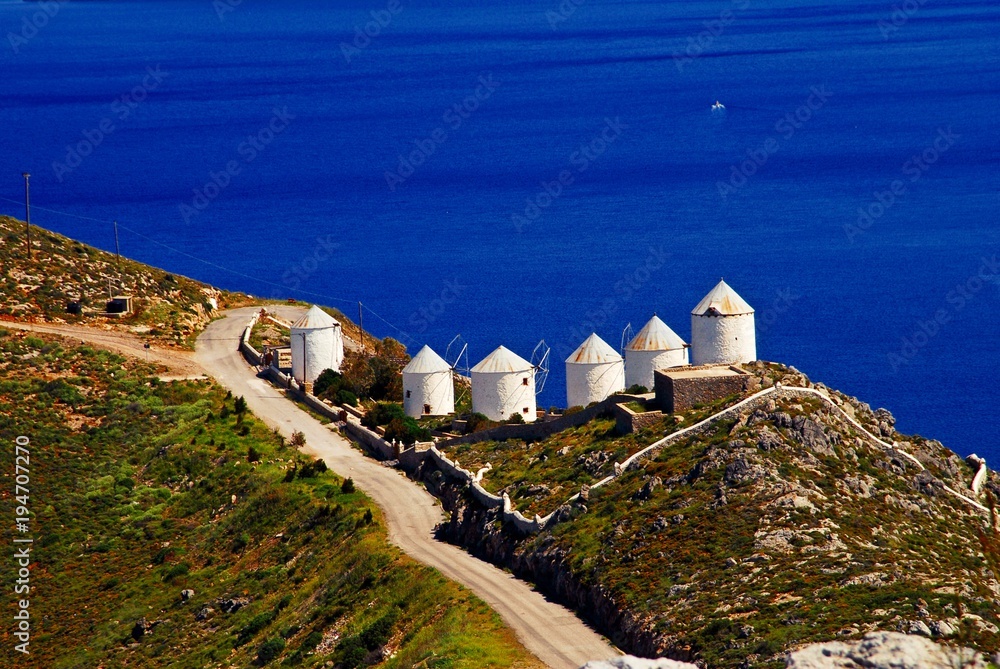 Landscape of Leros island with old traditional windmills. Leros, Dodecanese islands, Greece.