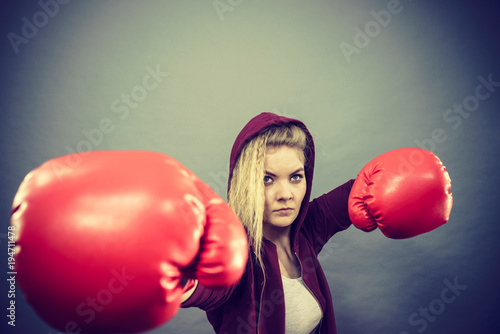 Woman wearing boxing gloves © Voyagerix