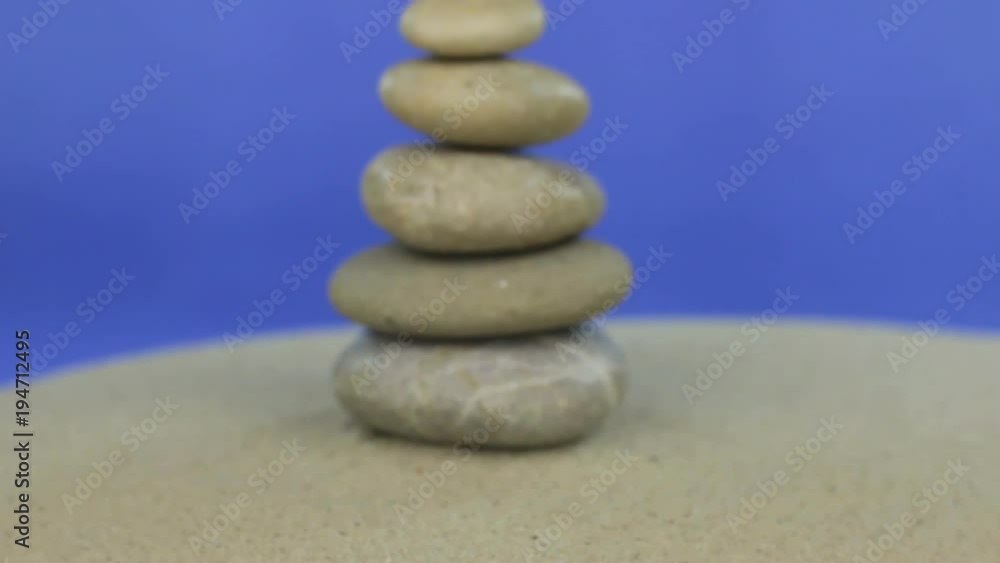 Approaching the pyramid made of stones standing on the sand. Isolated Approaching the pyramid made of stones standing on the sand. Isolated