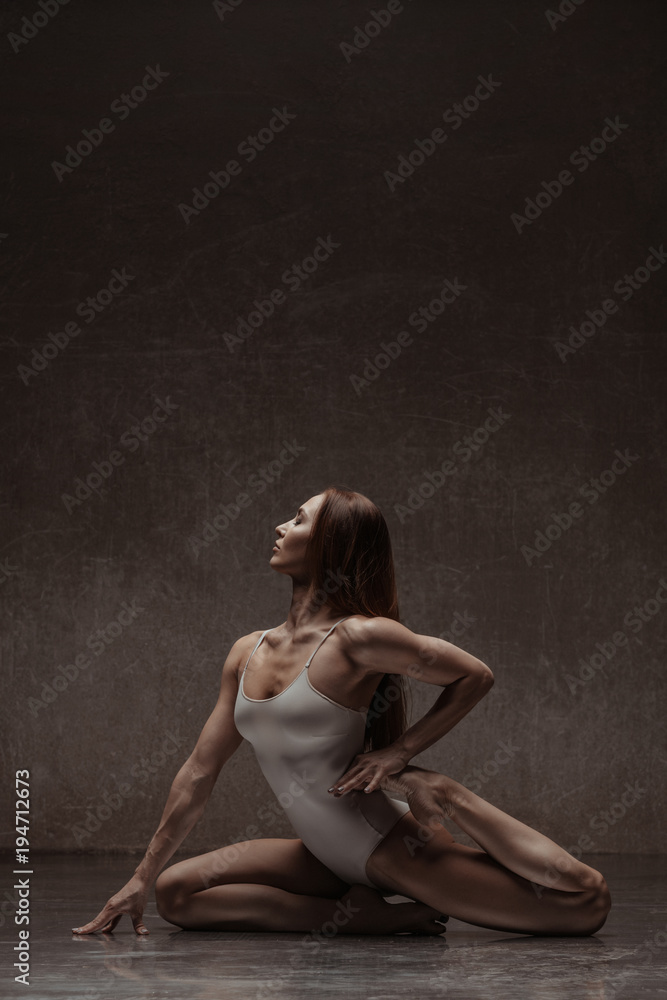 Young yoga woman stretching and training in class Young yoga woman stretching and training in class