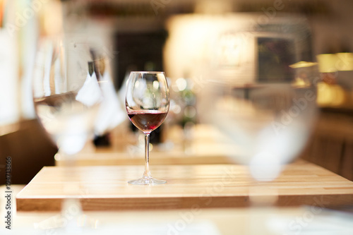 Selective focus of glass with red wine at restaurant