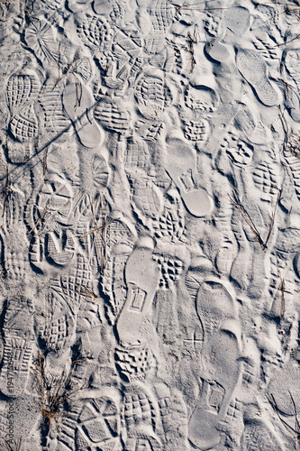 Various of footprints on dry sand floor background