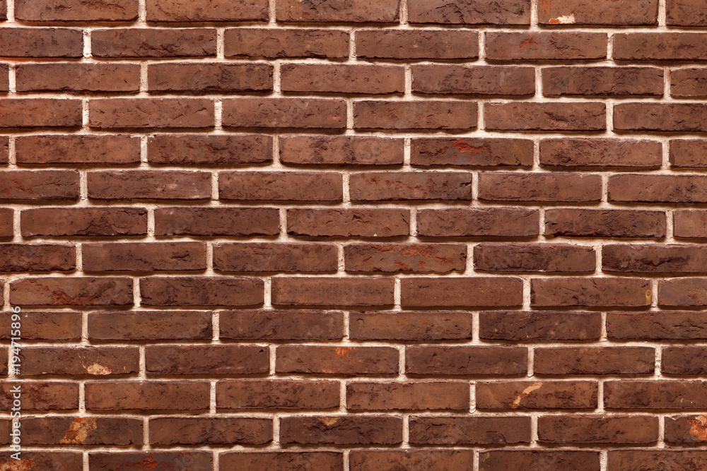 Obraz premium Decorative, neat wall made of brown ceramic bricks, inside.