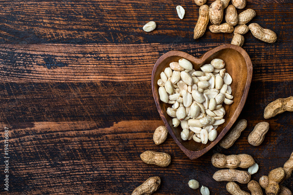 Peanuts snack in bowl on dark background Peanuts snack in bowl on dark background