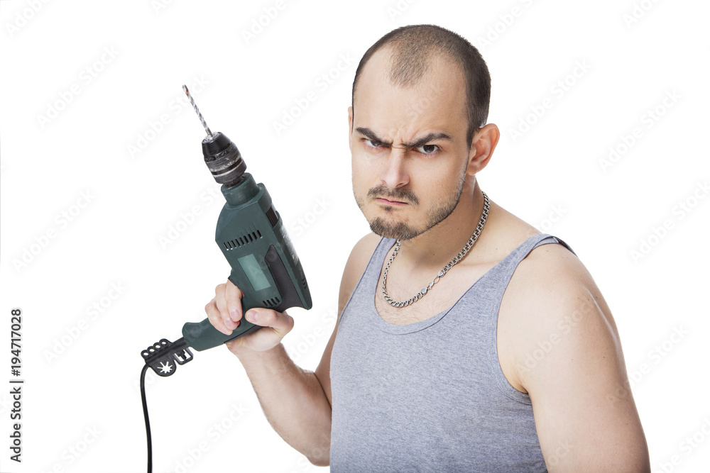 Handsome caucasian man in casual clothes doing his man's job - drilling holes with a drill tool. He looks serious and professional. Isolated on white Handsome caucasian man in casual clothes doing his man's job - drilling holes with a drill tool. He looks serious and professional. Isolated on white