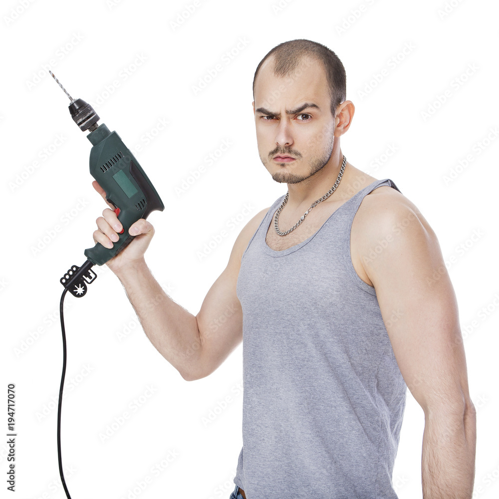 Handsome caucasian man in casual clothes doing his man's job - drilling holes with a drill tool. He looks serious and professional. Isolated on white Handsome caucasian man in casual clothes doing his man's job - drilling holes with a drill tool. He looks serious and professional. Isolated on white