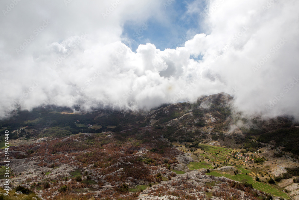 mountain view with thick clouds down to the lowland in Montenegro