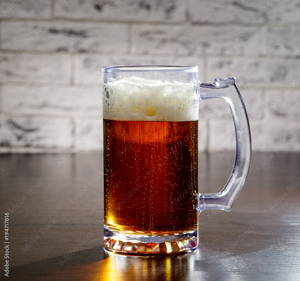 Beer with foam in glass is worth on the table. Beer with foam in glass is worth on the table.
