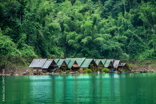 Small indigenous settlement on the banks of a river in the jungle photo