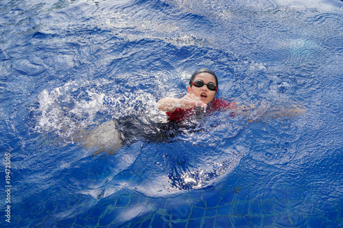 Happy children in the swimming pool. Funny kids playing outdoors. Summer vacation concept