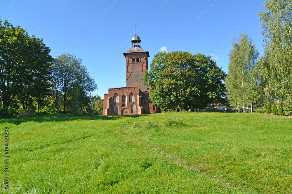 Fototapeta premium View of Saint Yakov's Lutheran church among trees. Znamensk, Kaliningrad region