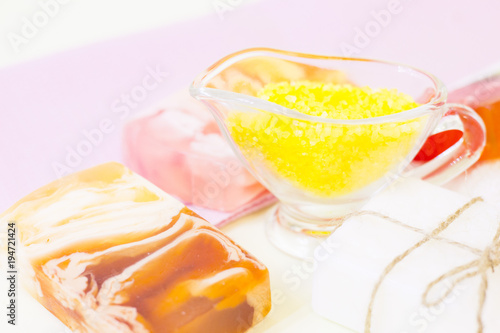 Aromatherapy spa concept. Colorful bars of soap, orange sea salt, closeup, white background