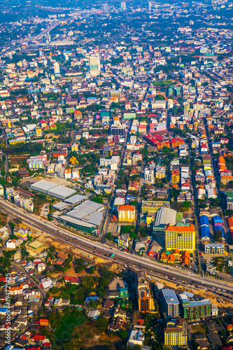 The view of Chiang Mai metropolis in Thailand from the sky with buildings and nature in the afternoon of sunny day. © guidenuk