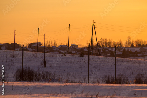 sunset in the winter frosty evening in the Russian outback