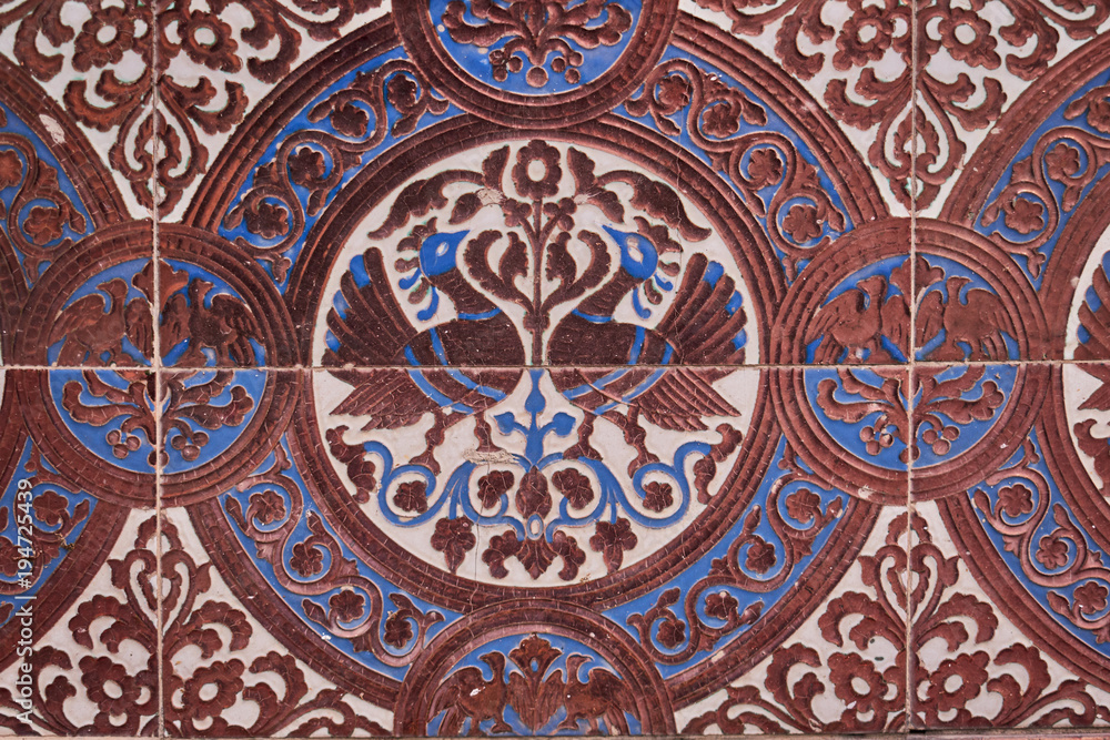 Close up of brown and blue drawings on tiles for pattern and background