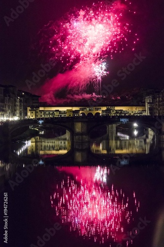 Obraz na plátně Fireworks by the historic Ponte Vecchio bridge in Florence, for the patron saint