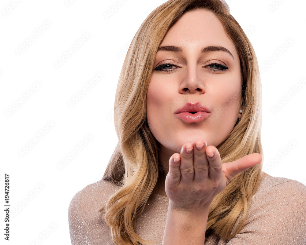 Attractive cute blonde. Close-up portrait on a white. Beautiful young woman in a flesh-colored dress.
