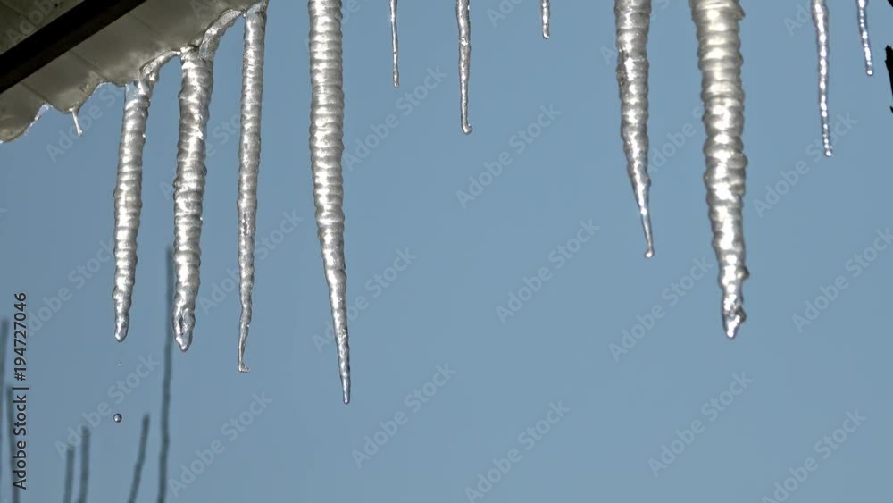 Zoom to closeup of icycles from a roof in a sunny day
Zoom to closeup of icycles from a roof in a sunny day