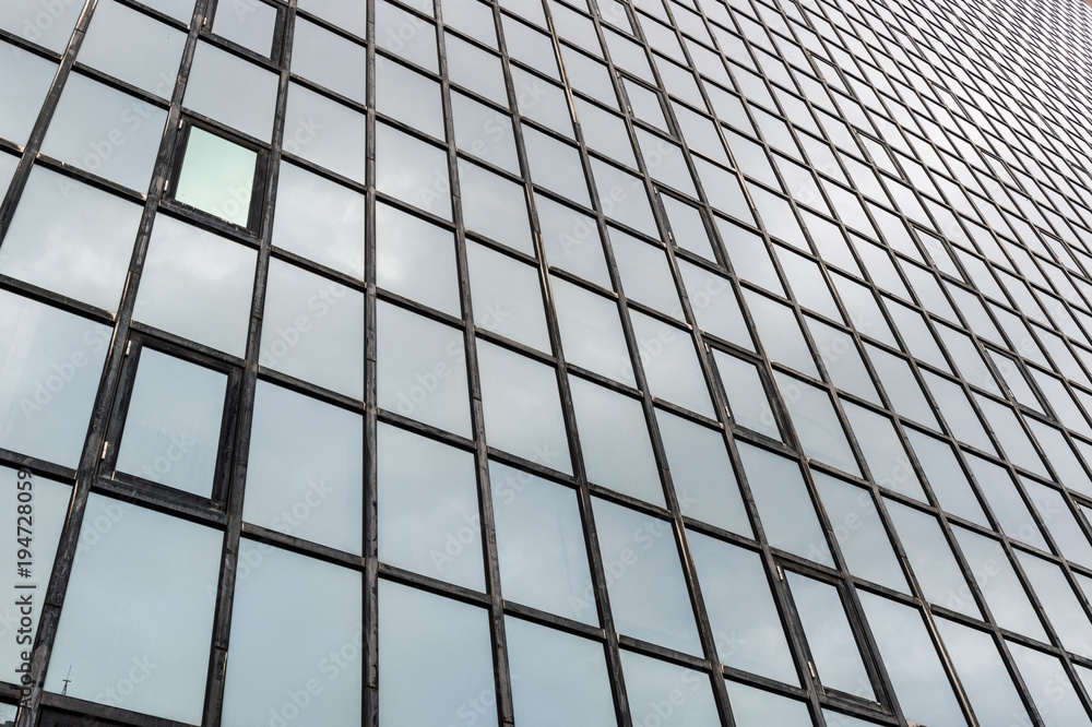 Glass surface of skyscrapers view in district of business centers with reflection on it, black and white Glass surface of skyscrapers view in district of business centers with reflection on it, black and white